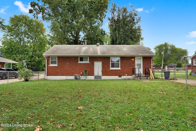 view of front of house with central AC and a front lawn