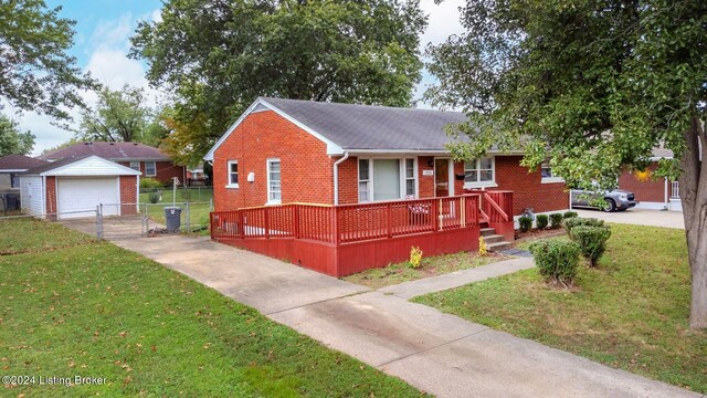 view of front of house featuring an outdoor structure, a front yard, and a garage