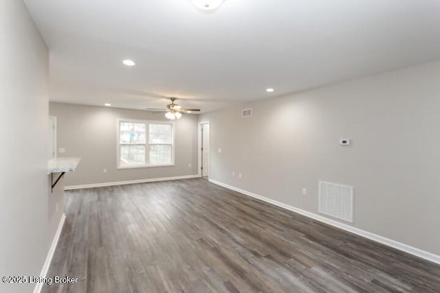 unfurnished living room with ceiling fan and dark hardwood / wood-style floors