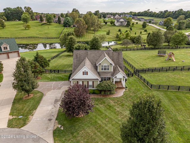 birds eye view of property featuring a water view and a rural view