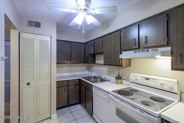 kitchen featuring sink, white appliances, a textured ceiling, and ceiling fan