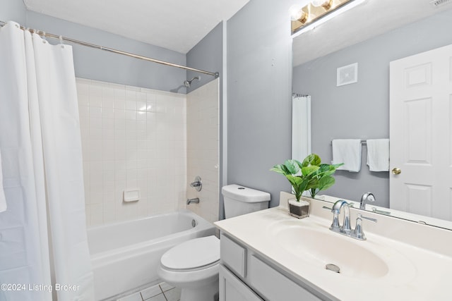 full bathroom with tile patterned floors, vanity, toilet, and shower / bath combo with shower curtain