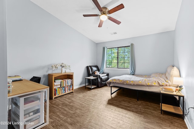 bedroom with hardwood / wood-style floors, vaulted ceiling, and ceiling fan