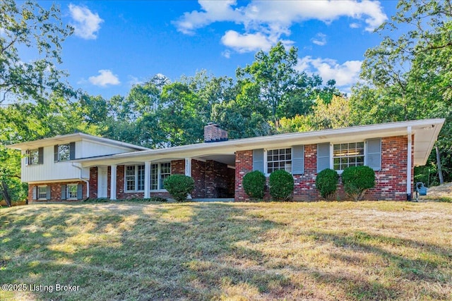 tri-level home with a front lawn