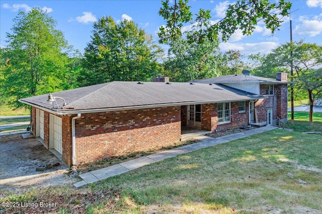 exterior space featuring a garage and a lawn