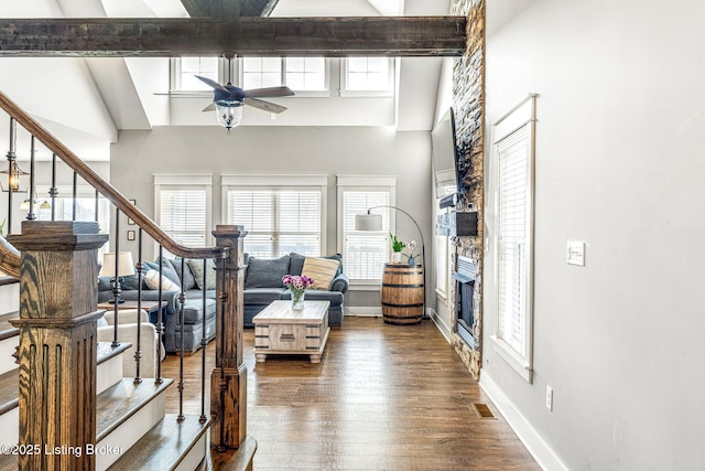 living room featuring ceiling fan, beamed ceiling, high vaulted ceiling, and hardwood / wood-style flooring