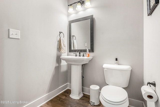 bathroom featuring hardwood / wood-style flooring and toilet