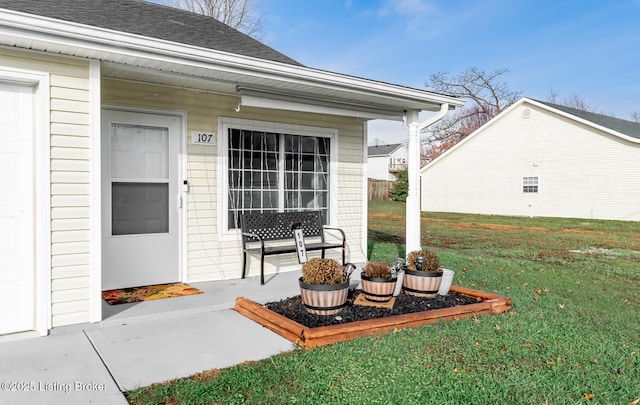 doorway to property featuring a yard