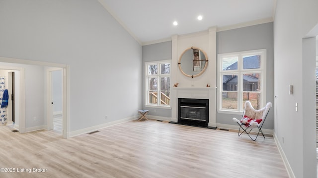 unfurnished living room featuring crown molding, plenty of natural light, and high vaulted ceiling