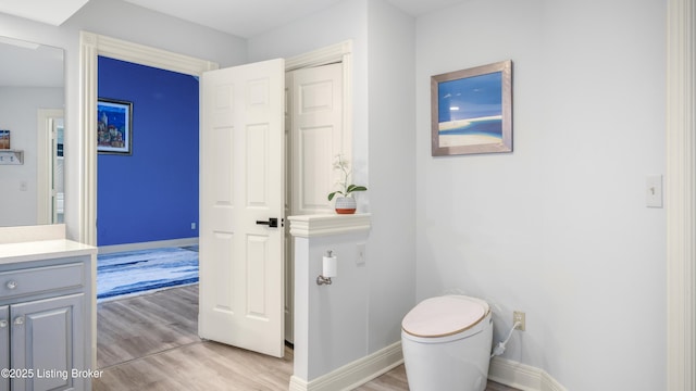 bathroom with vanity, hardwood / wood-style floors, and toilet