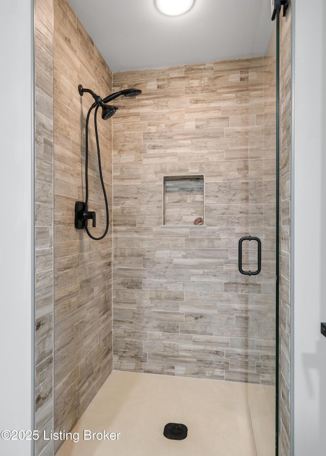 bathroom featuring a shower with shower door