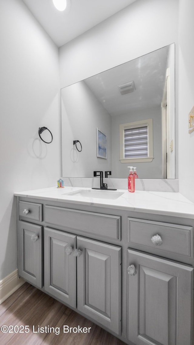 bathroom featuring hardwood / wood-style flooring and vanity