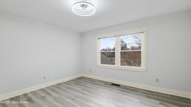 unfurnished room with light wood-type flooring