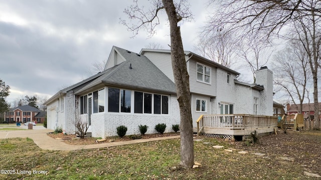 view of property exterior featuring a garage and a deck