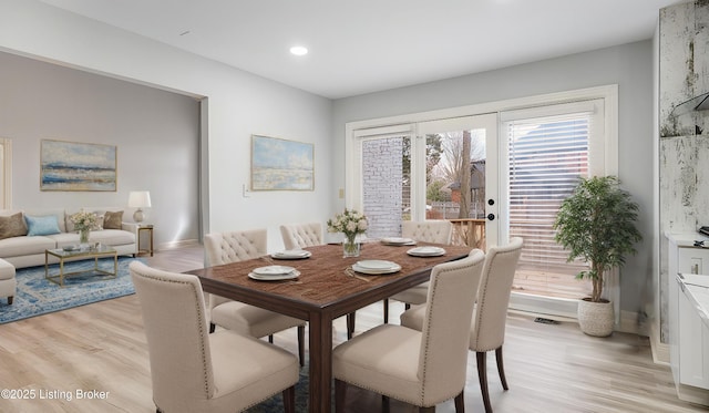 dining space with light wood-type flooring