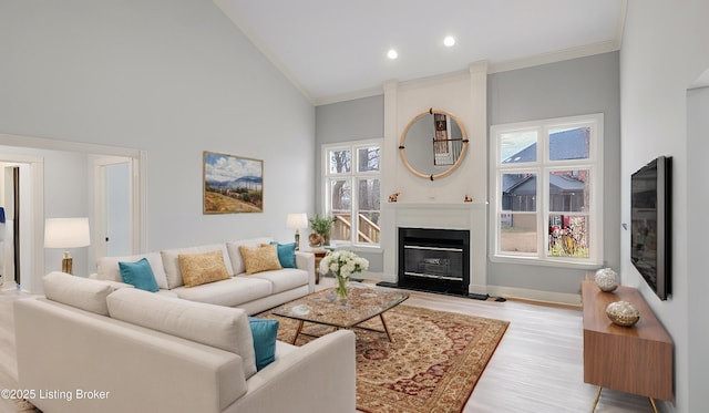 living room featuring ornamental molding, high vaulted ceiling, and light wood-type flooring