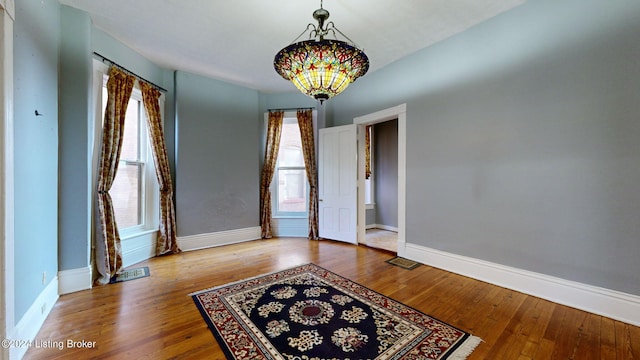 unfurnished room featuring hardwood / wood-style flooring