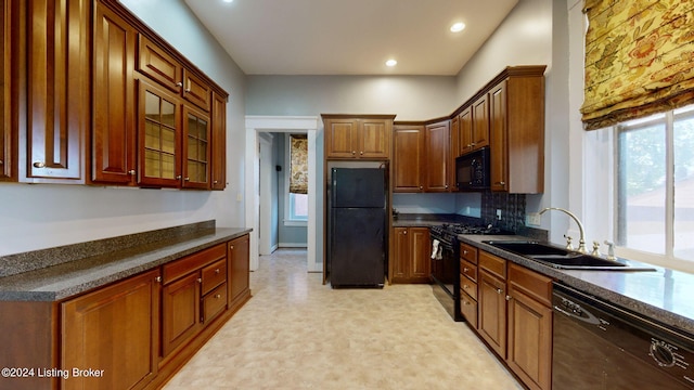 kitchen with black appliances, sink, and tasteful backsplash