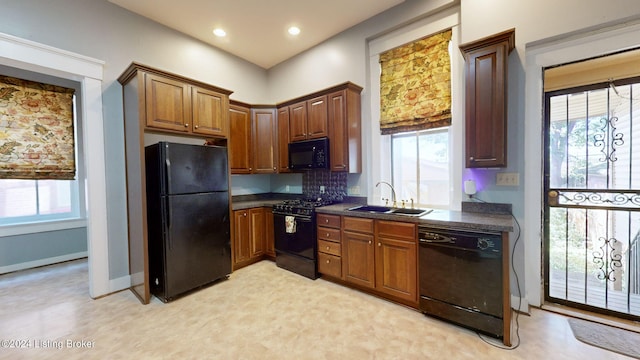 kitchen featuring black appliances, sink, and tasteful backsplash