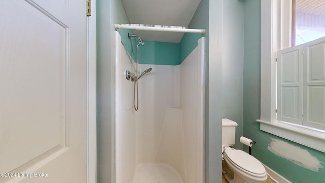 bathroom with walk in shower and toilet