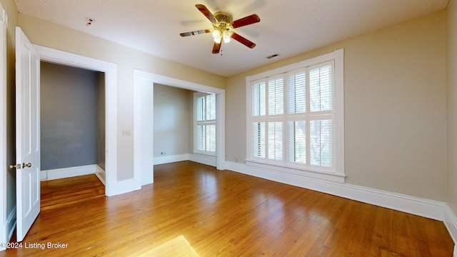 unfurnished room with ceiling fan and light wood-type flooring