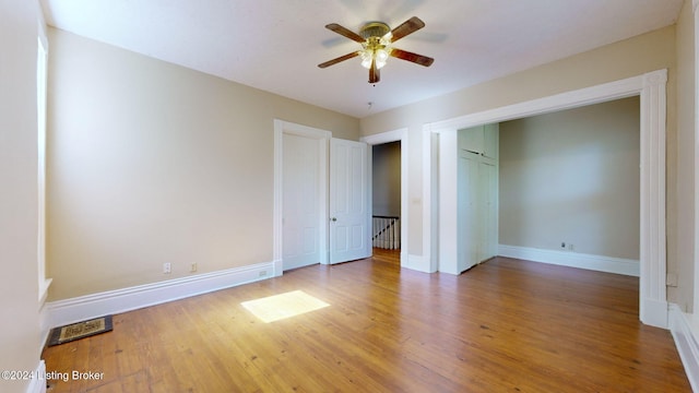 unfurnished bedroom featuring ceiling fan, a closet, and wood-type flooring