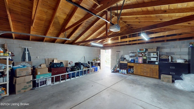 garage with a garage door opener and wooden ceiling