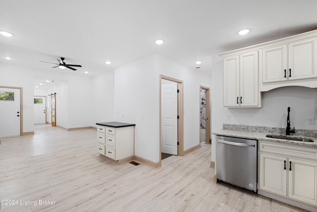 kitchen with dark stone counters, ceiling fan, sink, light hardwood / wood-style flooring, and dishwasher