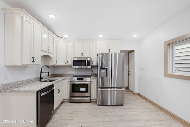 kitchen with white cabinets, sink, and stainless steel appliances