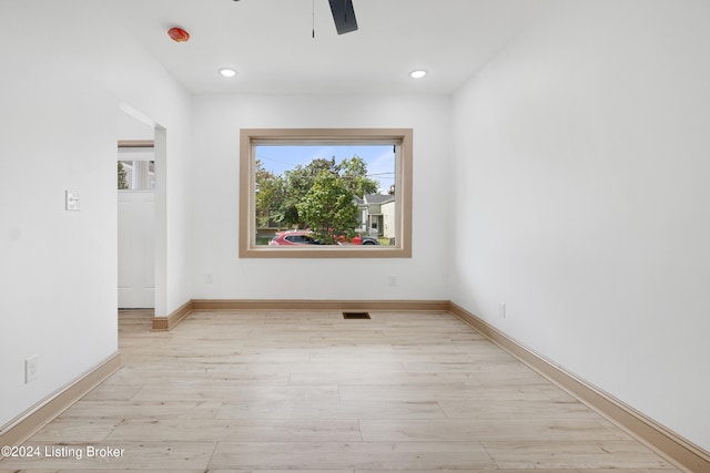 spare room featuring light hardwood / wood-style flooring and ceiling fan