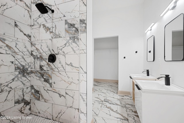 bathroom featuring a tile shower and vanity