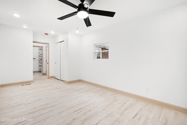 unfurnished room with ceiling fan and light wood-type flooring