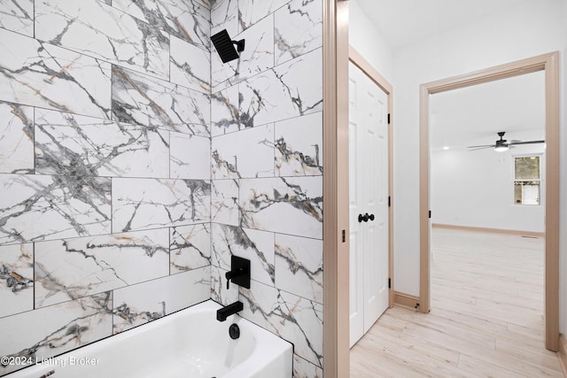 bathroom with ceiling fan and shower / washtub combination