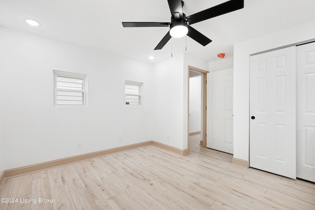 unfurnished bedroom featuring ceiling fan, light hardwood / wood-style flooring, and a closet