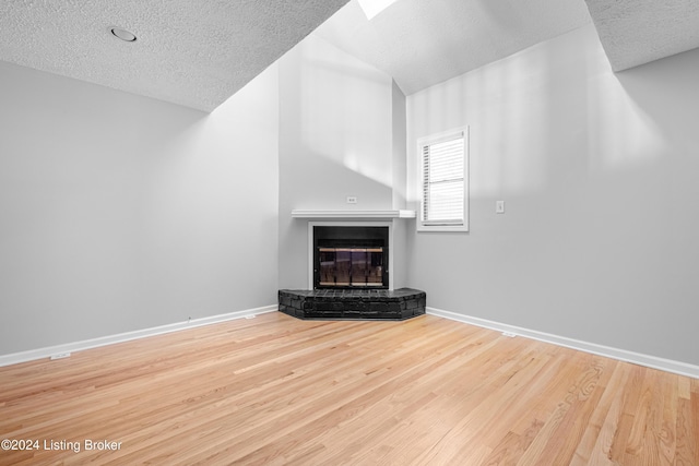 unfurnished living room with a textured ceiling and hardwood / wood-style flooring