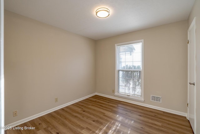 unfurnished room featuring hardwood / wood-style floors