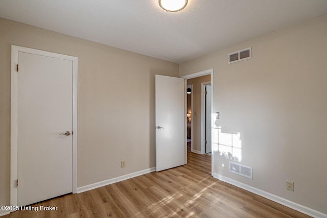 unfurnished bedroom with light wood-type flooring