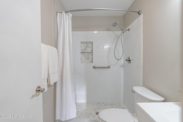 bathroom featuring toilet, vanity, and walk in shower