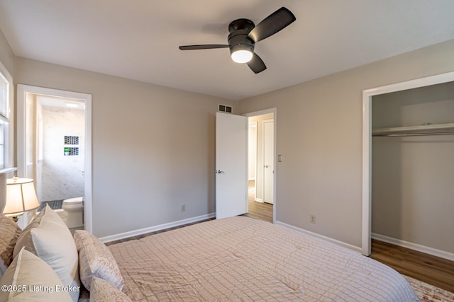 bedroom featuring ceiling fan, wood-type flooring, connected bathroom, and a closet