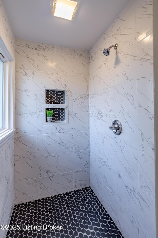 bathroom with a tile shower