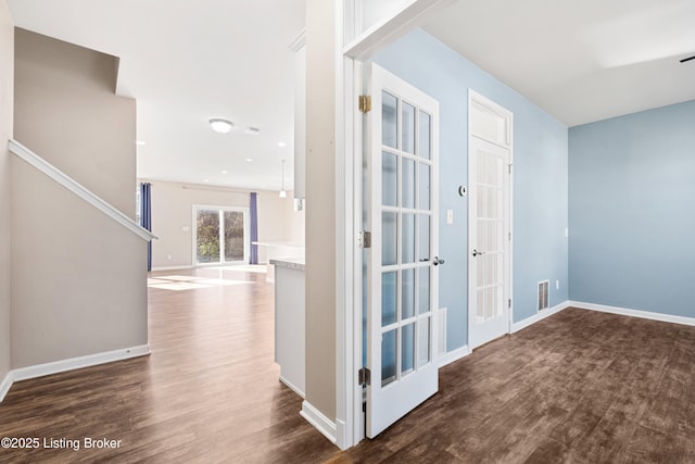 hall with french doors and dark hardwood / wood-style flooring