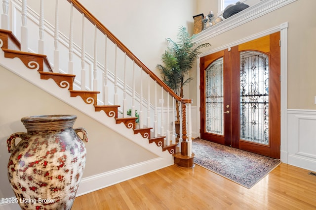 entrance foyer with hardwood / wood-style flooring and french doors