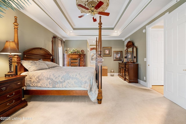 bedroom with a raised ceiling, ceiling fan, light carpet, and ornamental molding