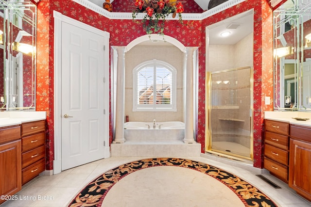 bathroom featuring decorative columns, tile patterned flooring, vanity, and shower with separate bathtub