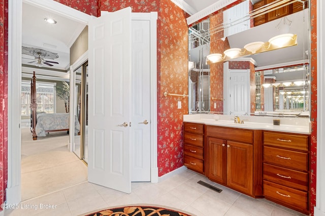 bathroom with tile patterned flooring, ceiling fan, crown molding, and vanity