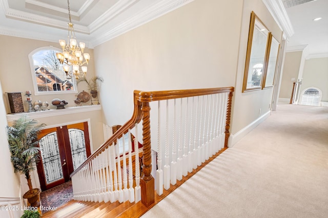 stairs with crown molding, french doors, and an inviting chandelier