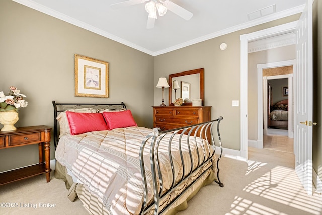 carpeted bedroom featuring ceiling fan and crown molding