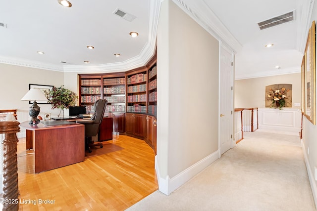 home office featuring crown molding and light hardwood / wood-style flooring