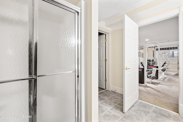 bathroom featuring a shower with shower door