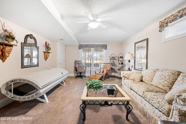 carpeted living room with a textured ceiling and ceiling fan